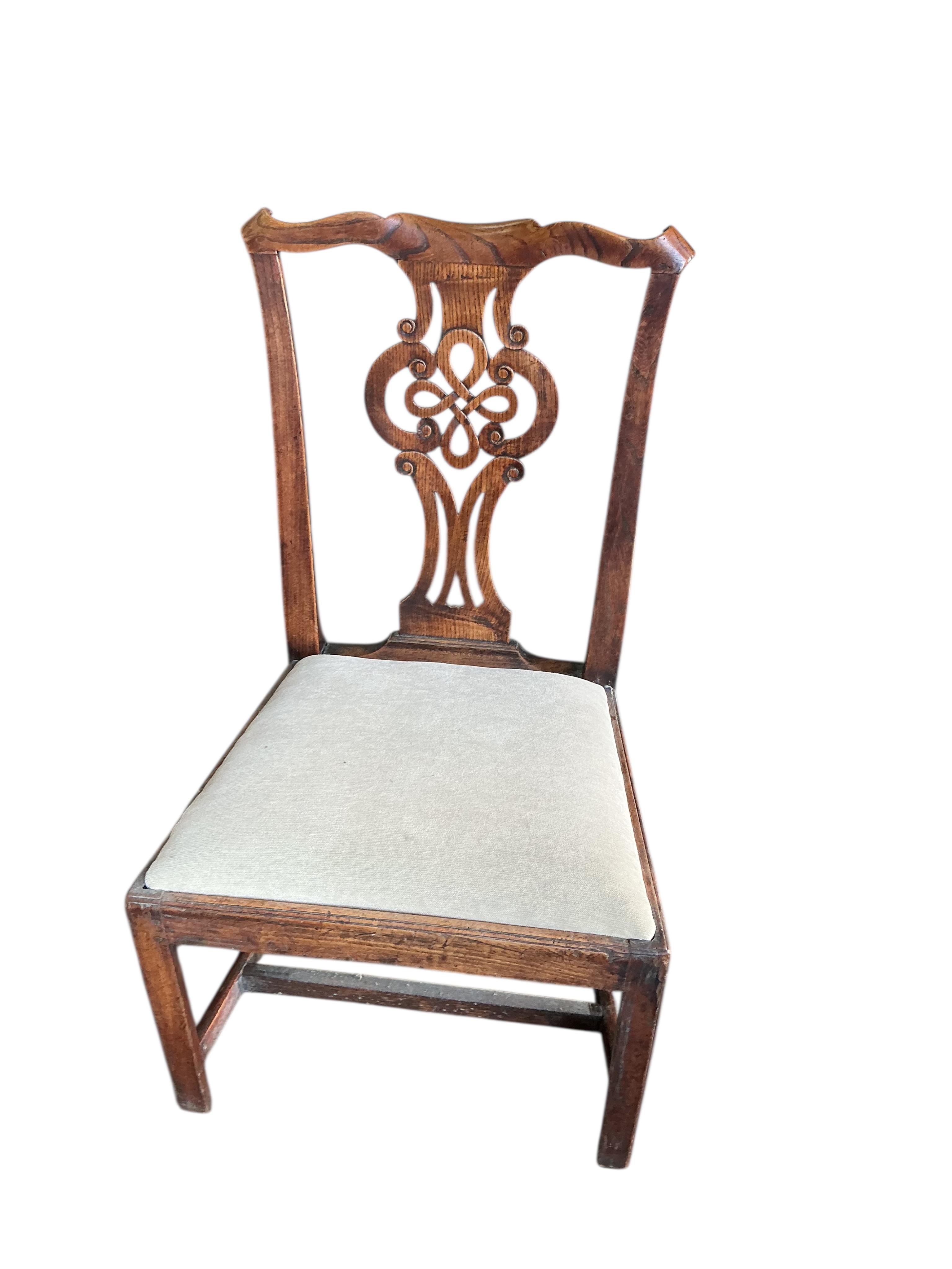 A Hepplewhite style painted mahogany elbow chair and a Regency cane seated single chair and a George III Provincial elm chair